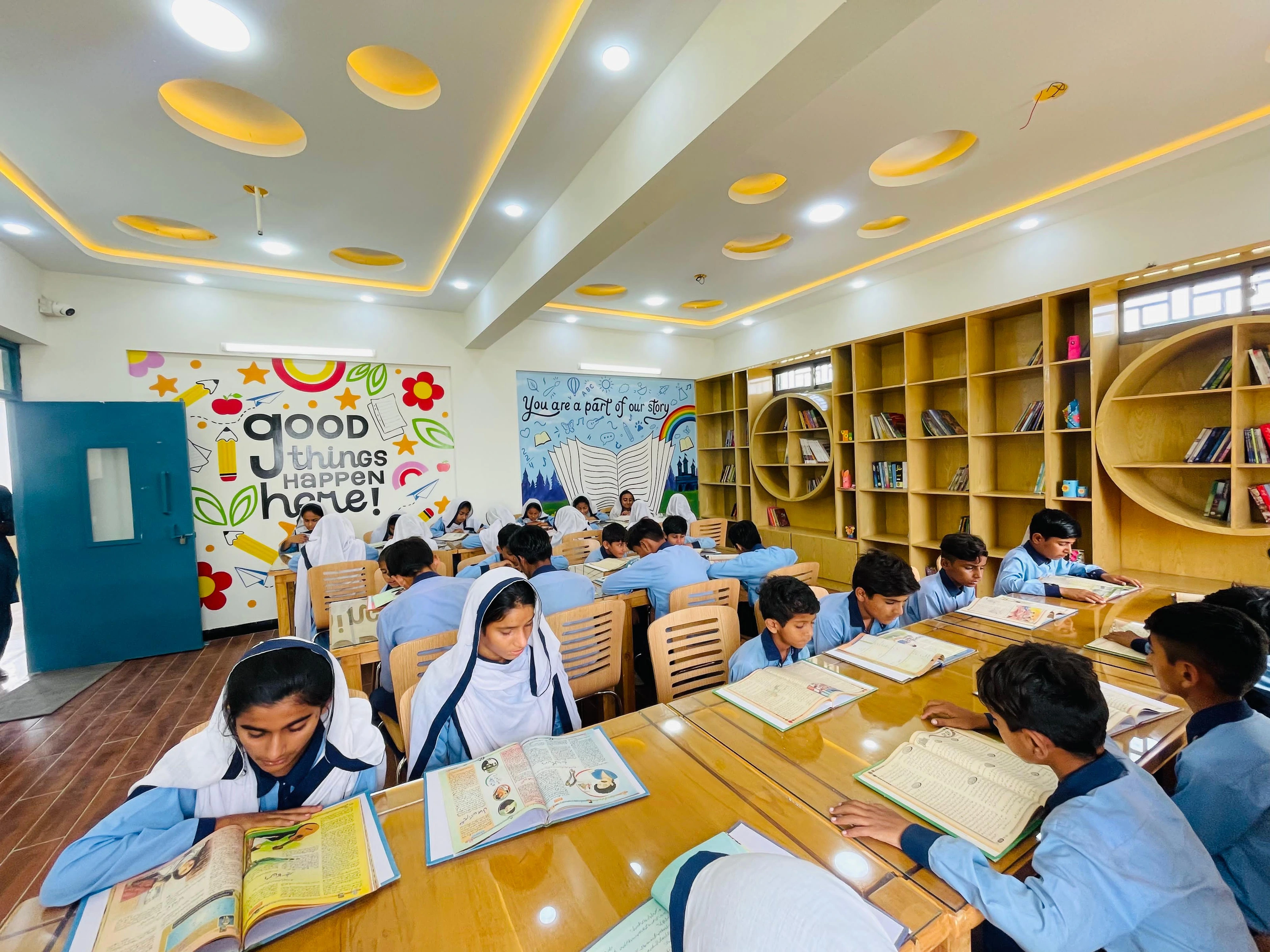 Students reading in a bright new school library in Karachi