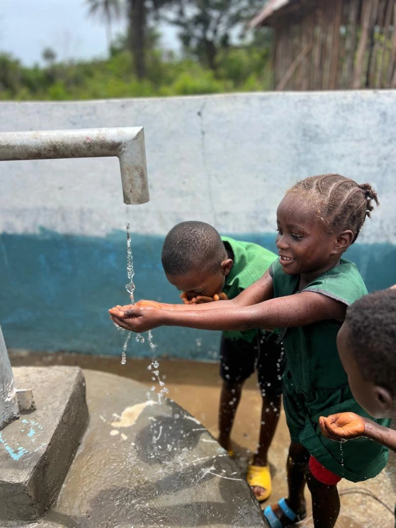 Children drinking clean water, Sierra Leone
